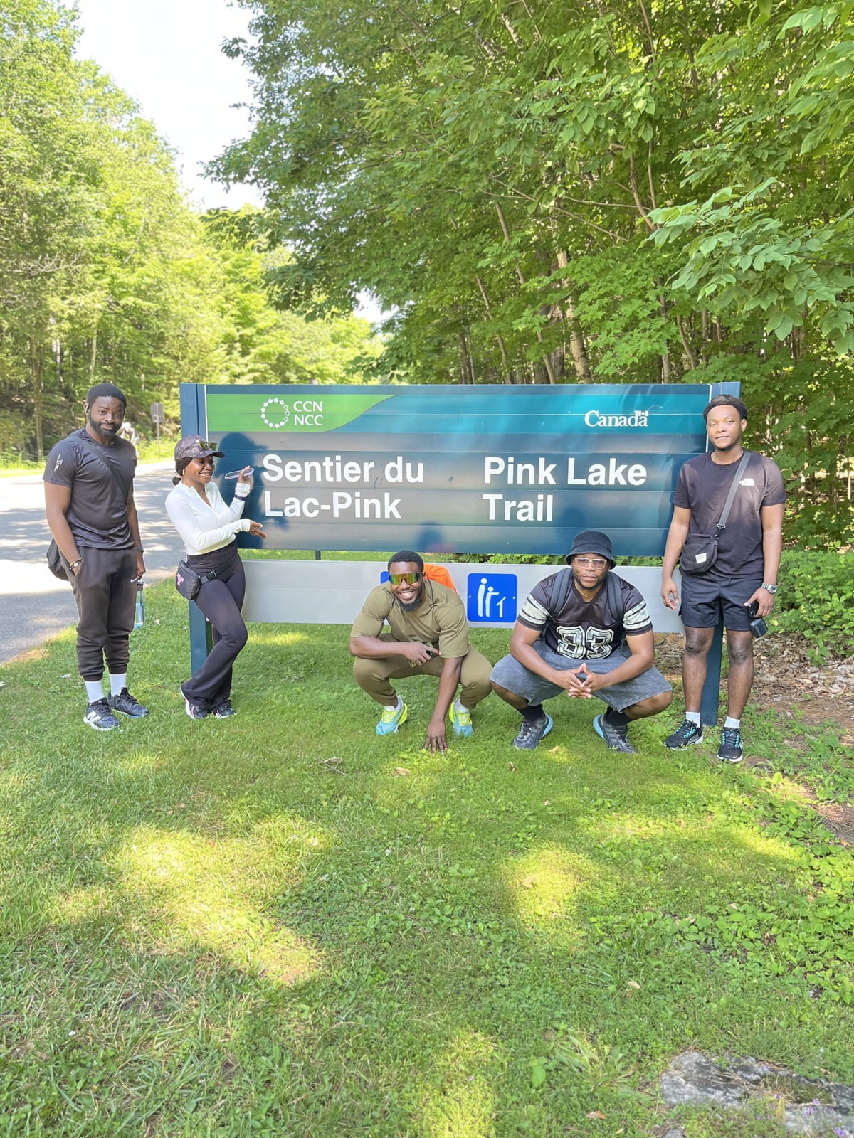 Members at the Pink Lake trail sign during a hike